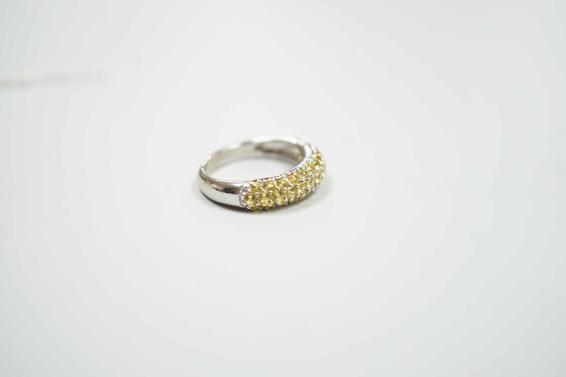 A modern 18ct white gold and yellow stone cluster set half hoop ring, size K, gross weight 4.2 grams.